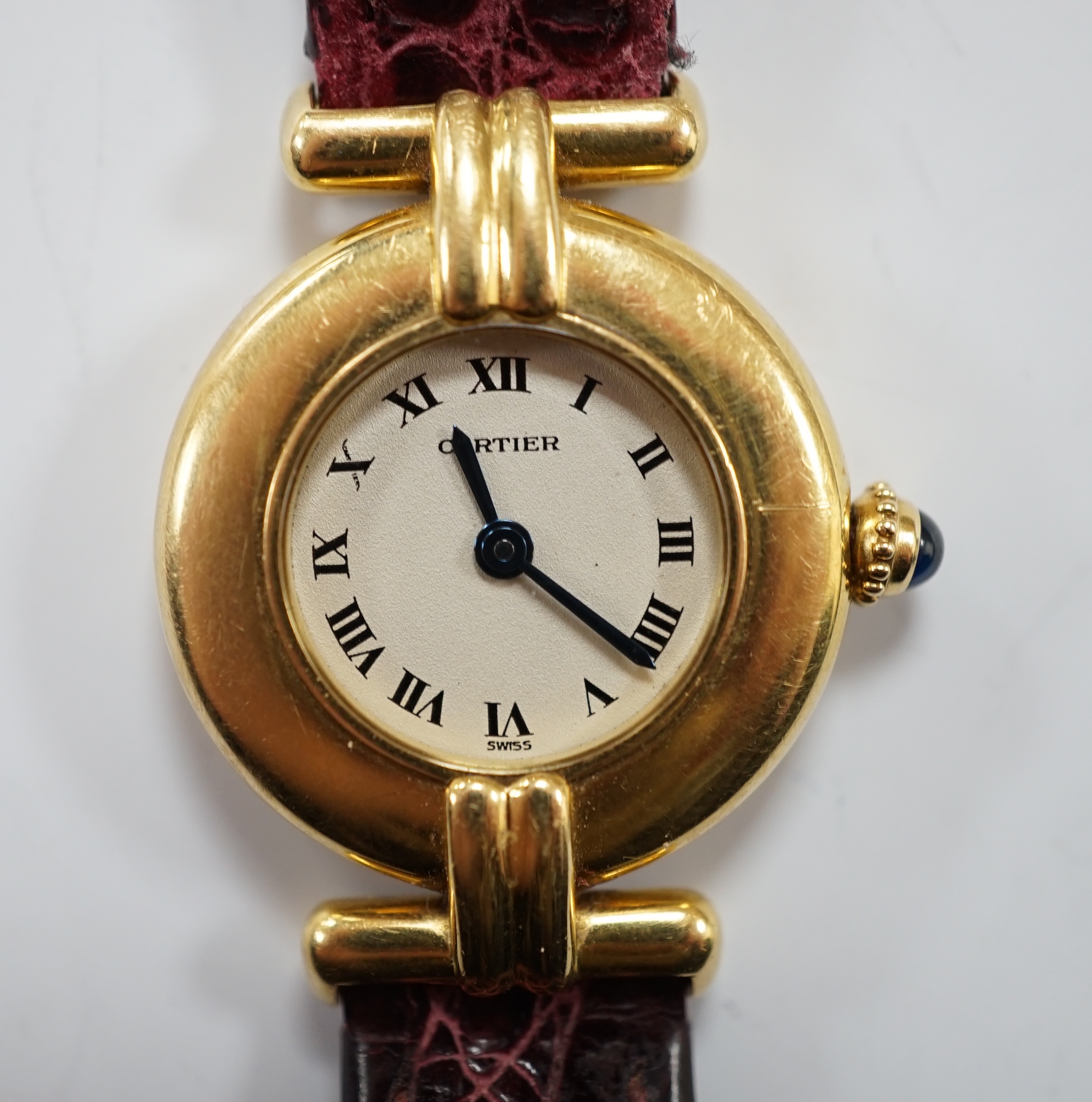 A lady's Cartier 18k Rivoli quartz wrist watch, with circular Roman dial and Cartier pouch and certificate dated 1987.